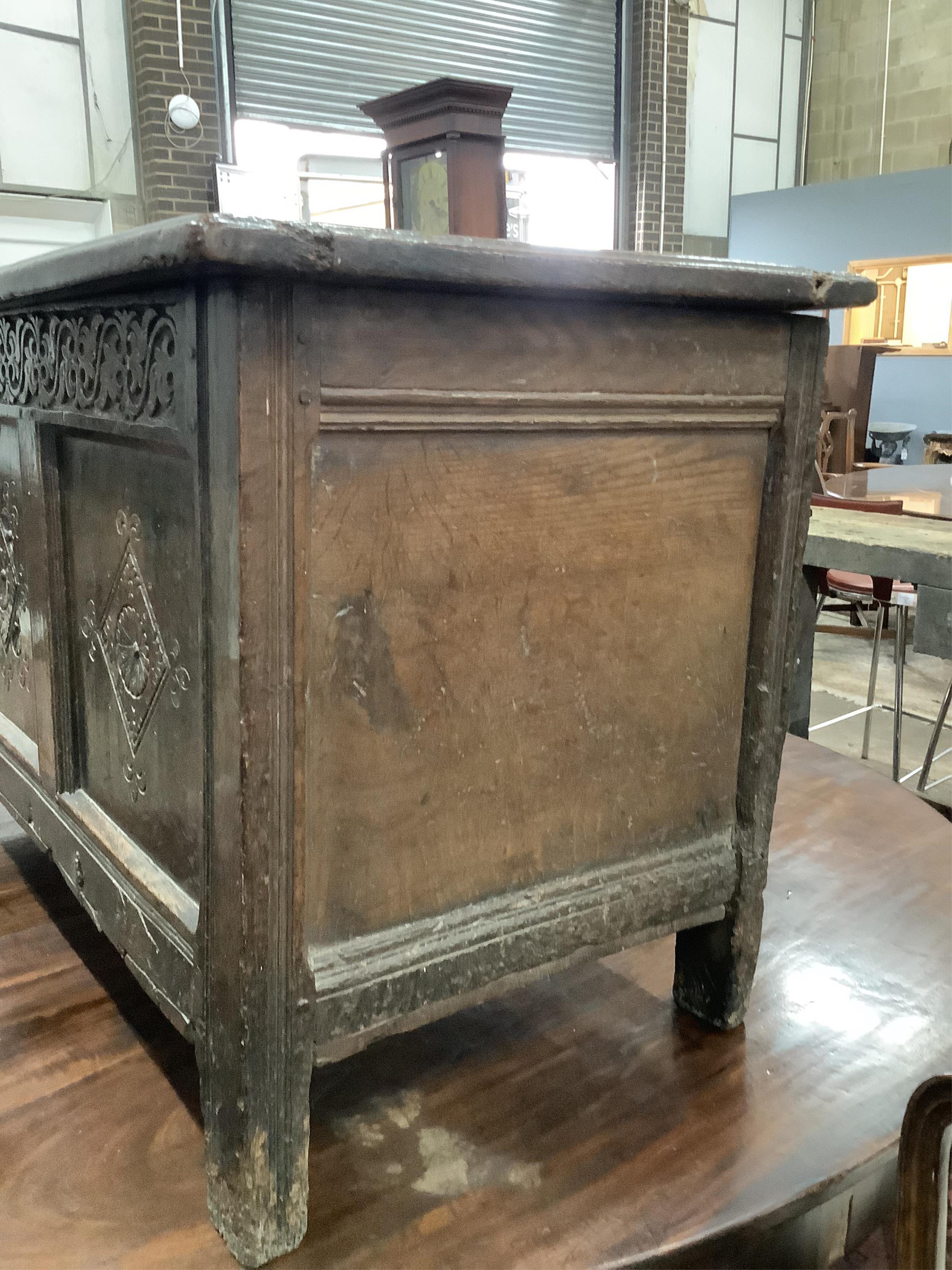 A late 17th century carved oak coffer, width 128cm, depth 56cm, height 66cm. Condition - poor